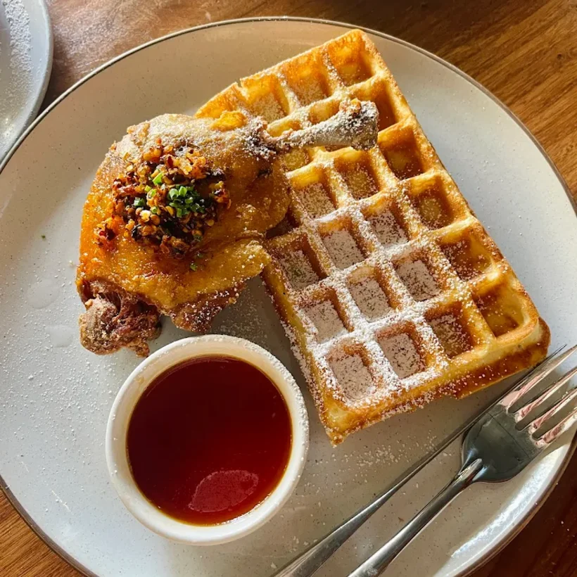 Fried chicken over a golden buttermilk waffle with syrup